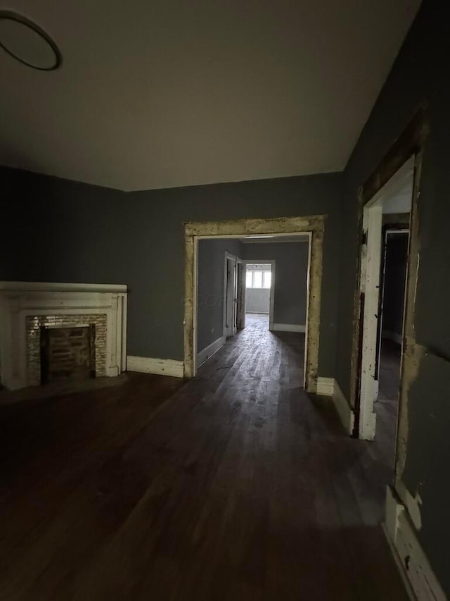 unfurnished living room with dark wood-type flooring