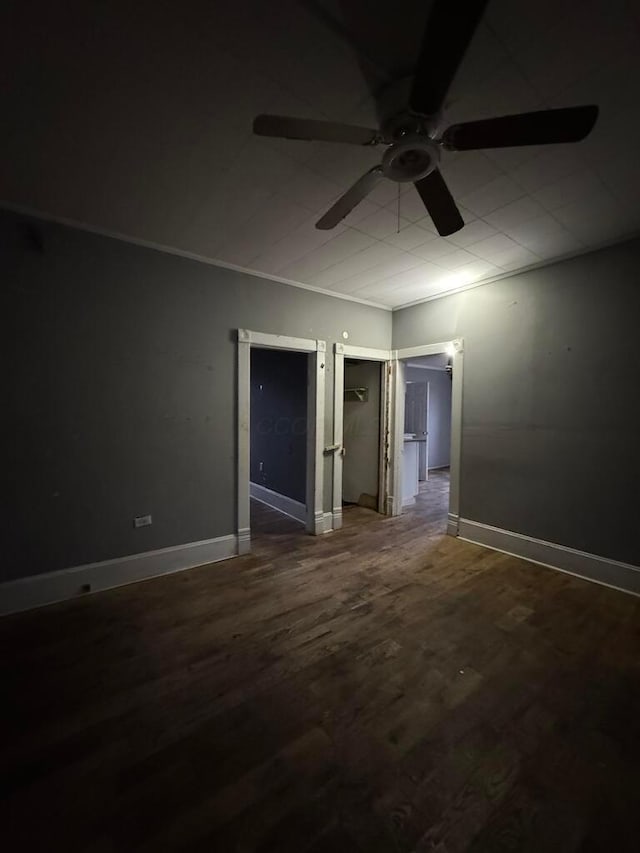 unfurnished room featuring ceiling fan, wood-type flooring, and ornamental molding