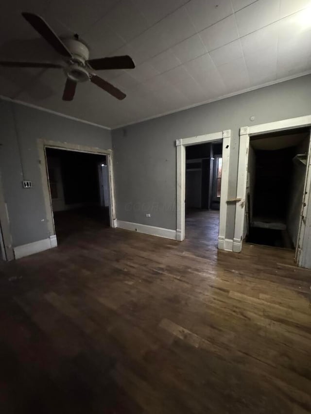 spare room with crown molding, dark hardwood / wood-style floors, and ceiling fan