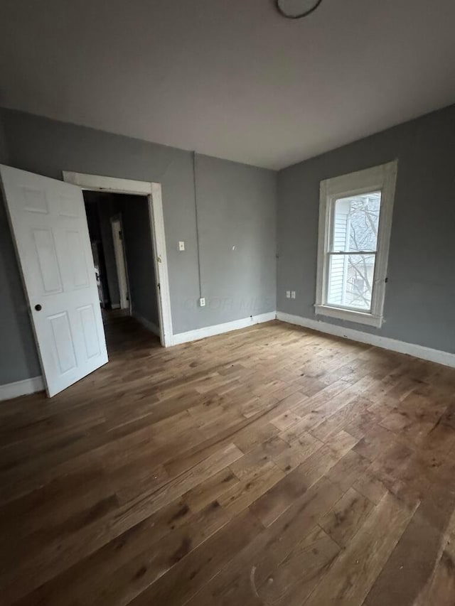 unfurnished room featuring dark hardwood / wood-style flooring