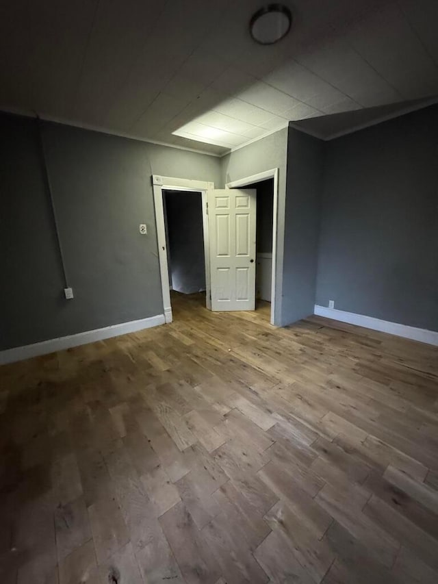 unfurnished room with wood-type flooring