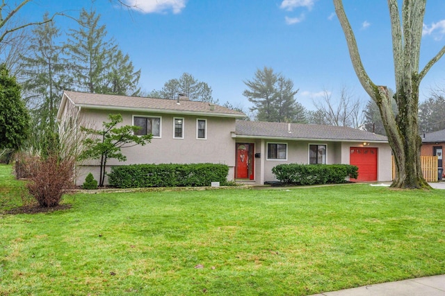 tri-level home with a garage and a front yard