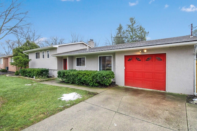 split level home with a garage and a front yard