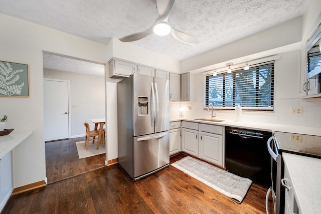 kitchen featuring stainless steel appliances, dark hardwood / wood-style floors, sink, and backsplash