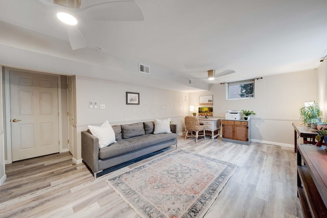 living room featuring ceiling fan and light hardwood / wood-style flooring