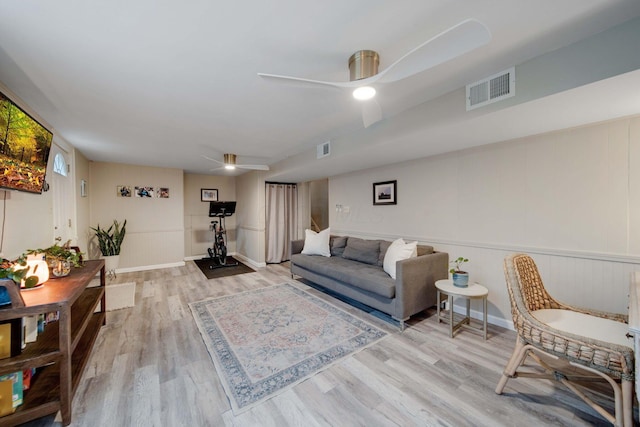 living room featuring light wood-type flooring and ceiling fan