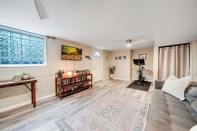 living room with ceiling fan and light wood-type flooring