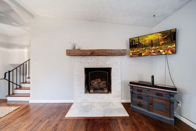 living room featuring vaulted ceiling, a textured ceiling, and dark hardwood / wood-style flooring