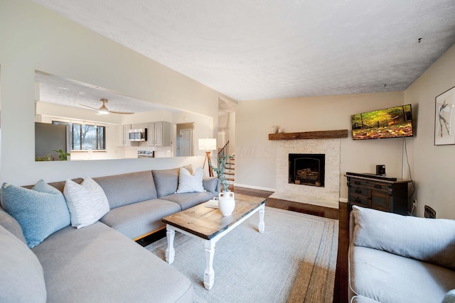 living room featuring lofted ceiling, wood-type flooring, and a textured ceiling