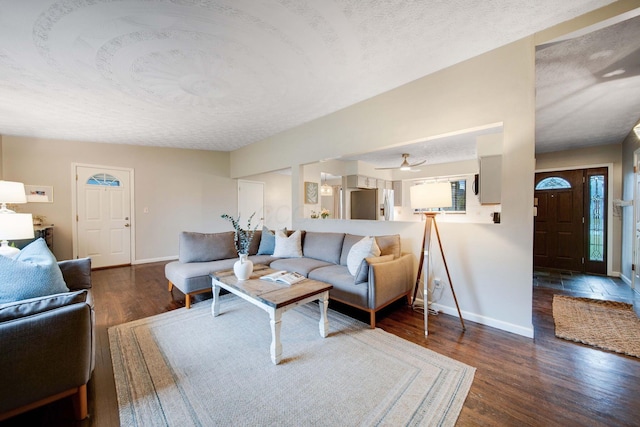 living room with dark hardwood / wood-style flooring and a textured ceiling