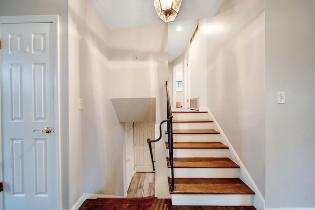 staircase with hardwood / wood-style flooring