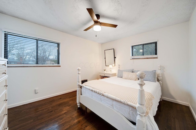 bedroom with dark hardwood / wood-style flooring and a textured ceiling