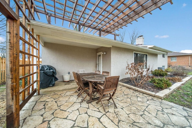 view of patio with a grill and a pergola