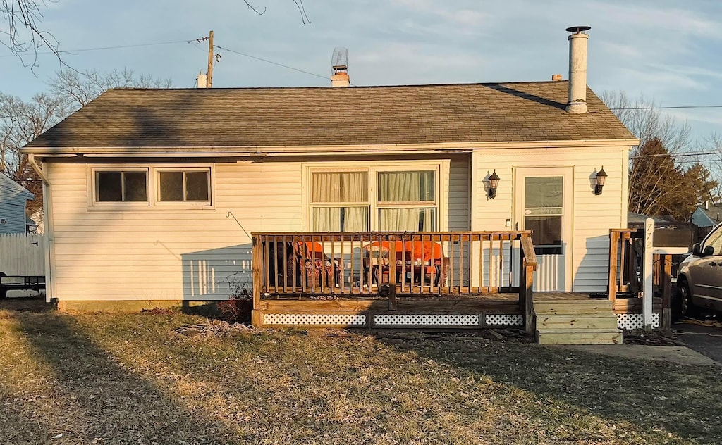 back of house featuring a yard and a deck