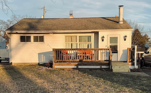 back of house featuring a yard and a deck