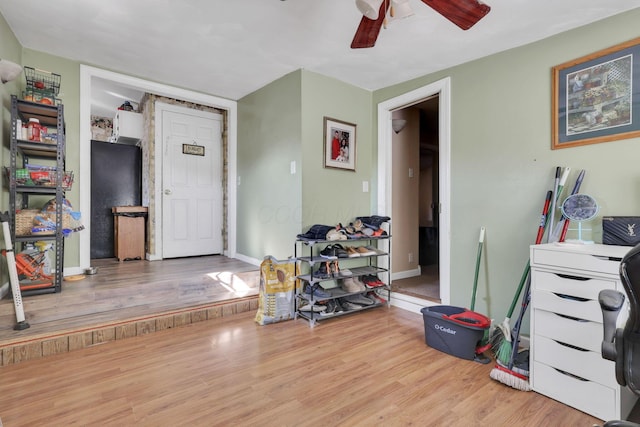 interior space featuring light wood-type flooring, ceiling fan, and baseboards