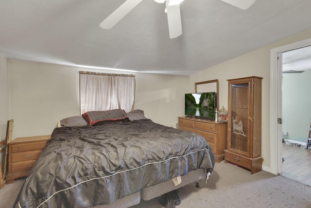 bedroom with ceiling fan, baseboards, and light colored carpet