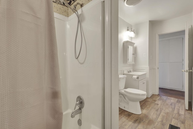 full bath featuring toilet, a wainscoted wall, wood finished floors, visible vents, and vanity