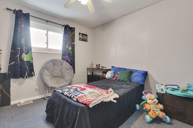 carpeted bedroom with a ceiling fan, visible vents, and baseboards