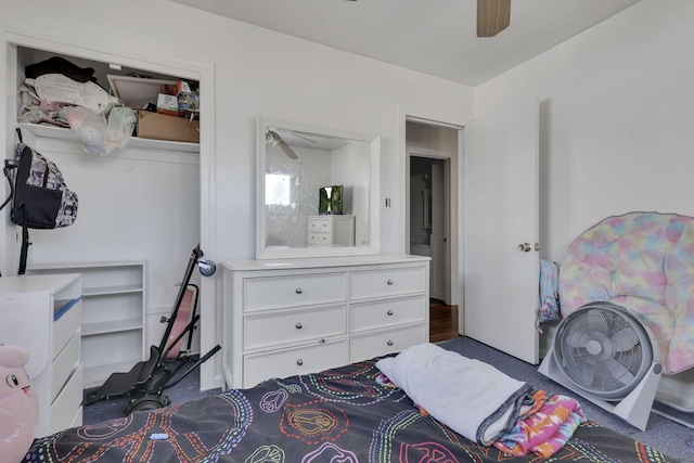 bedroom featuring ceiling fan and dark carpet