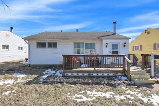 snow covered rear of property featuring a wooden deck