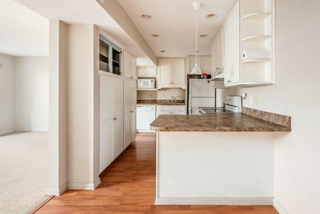 kitchen featuring sink, white cabinets, kitchen peninsula, white appliances, and light hardwood / wood-style flooring