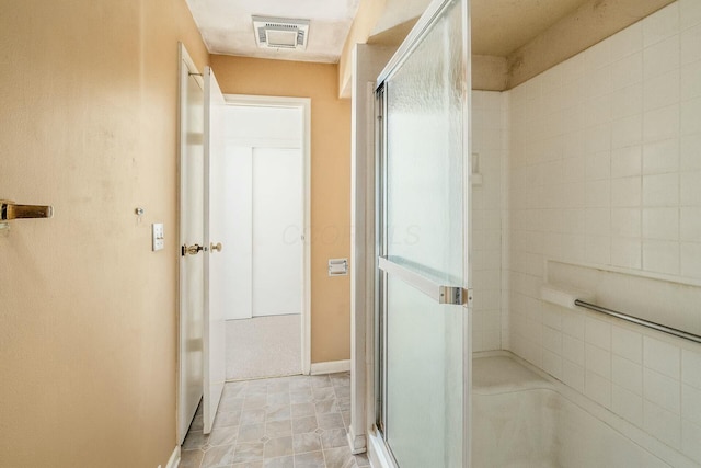 bathroom with a shower with door