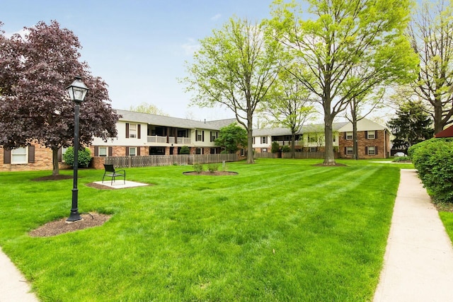 view of property's community with a lawn