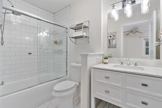 full bathroom featuring vanity, ceiling fan, enclosed tub / shower combo, and toilet