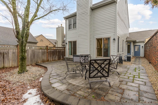 back of house featuring central air condition unit and a patio area