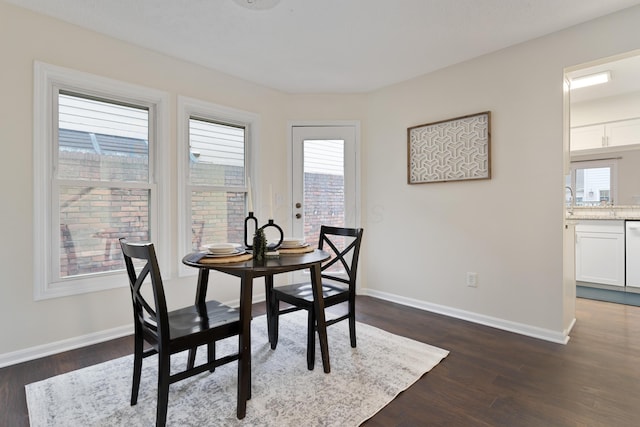 dining space with dark hardwood / wood-style flooring