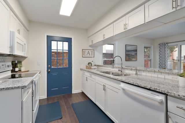 kitchen featuring sink, white cabinets, white appliances, and kitchen peninsula