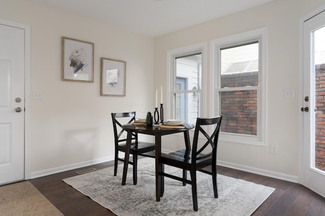 dining area featuring dark wood-type flooring