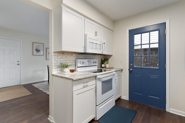 kitchen with dark hardwood / wood-style flooring, white appliances, decorative backsplash, and white cabinets