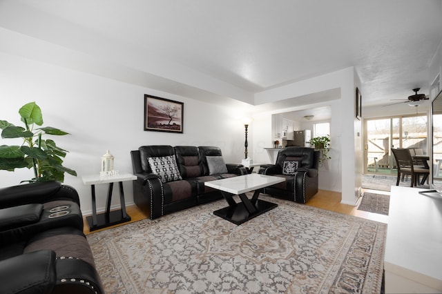 living room featuring light hardwood / wood-style flooring and ceiling fan