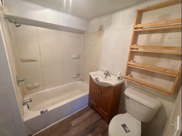 full bathroom with vanity, hardwood / wood-style floors, toilet, and shower / bathing tub combination