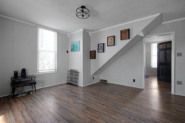 living room featuring crown molding and dark wood-type flooring