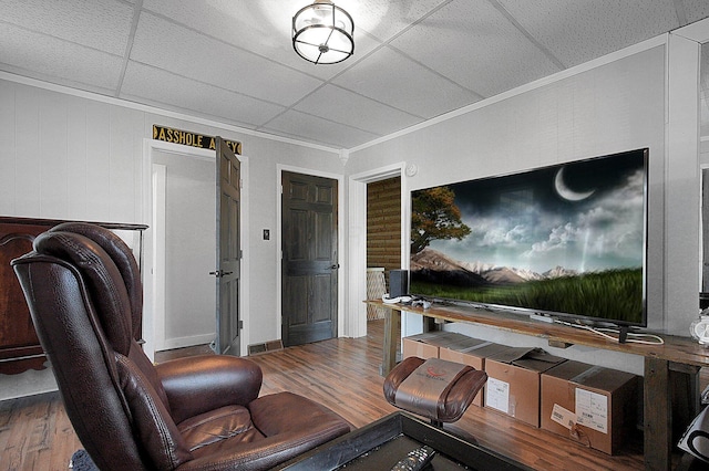 living room with a paneled ceiling and hardwood / wood-style floors