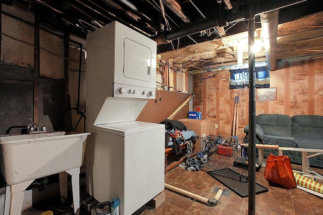 interior space featuring stacked washer / drying machine and sink