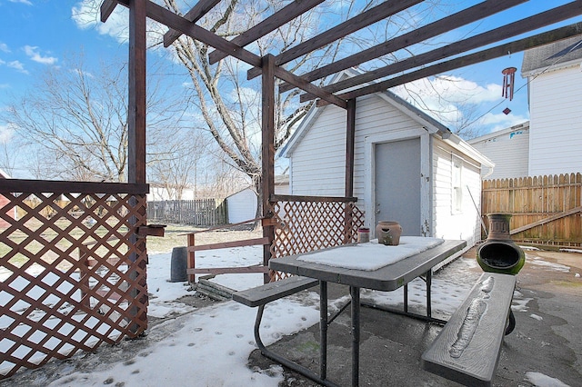 snow covered patio featuring an outbuilding