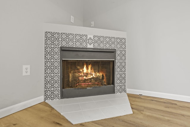 room details with hardwood / wood-style floors and a fireplace