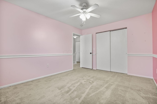 unfurnished bedroom with light carpet, a closet, and ceiling fan