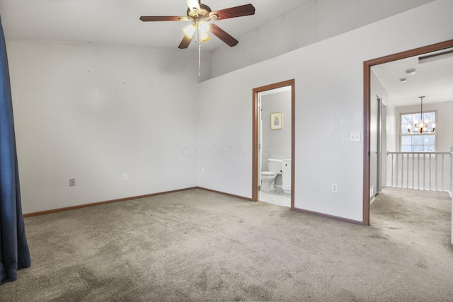 spare room with ceiling fan with notable chandelier and carpet floors