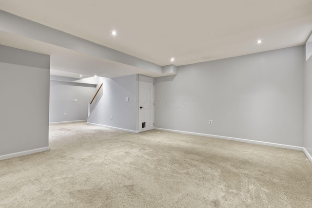 basement featuring light carpet