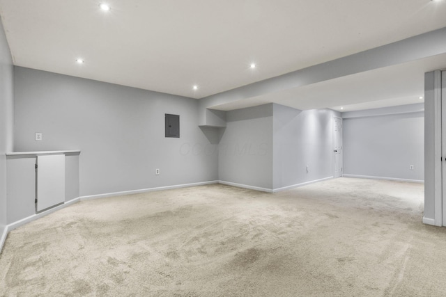 basement with electric panel and light carpet