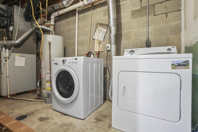 laundry area with water heater, heating unit, and washing machine and clothes dryer