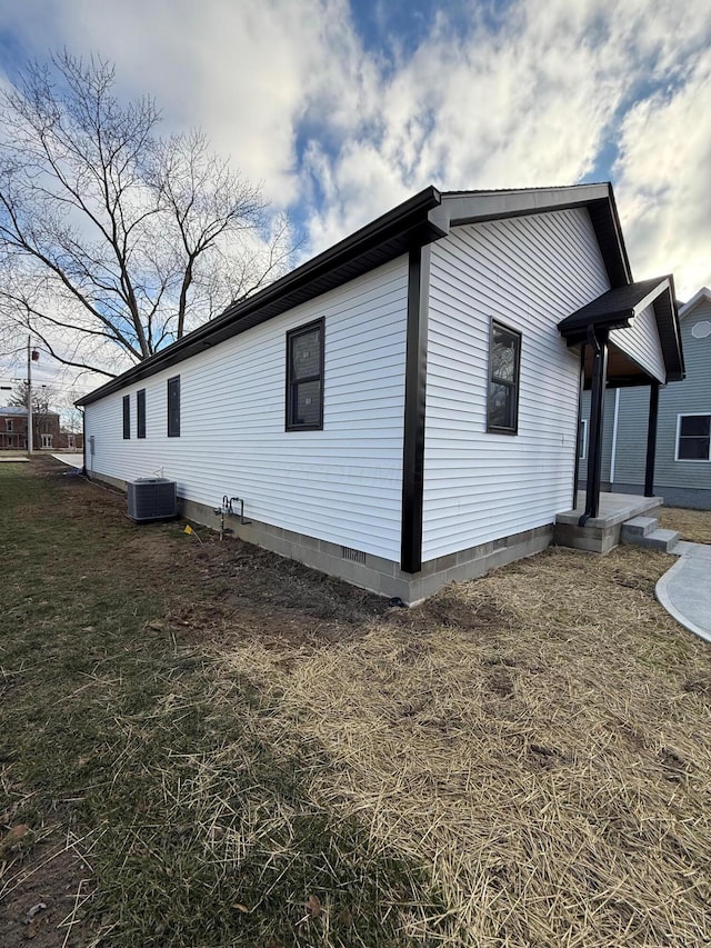 view of home's exterior featuring a lawn and central air condition unit