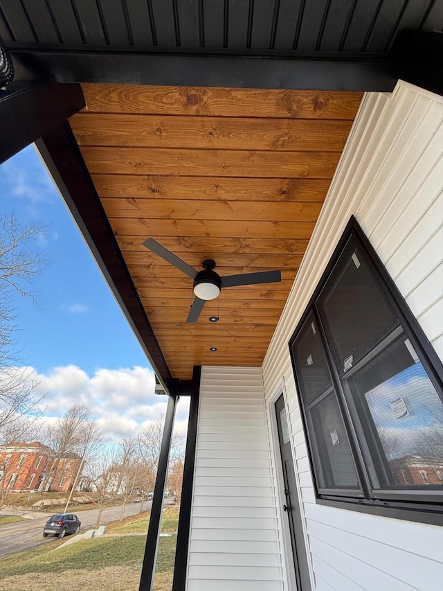 exterior details featuring a ceiling fan and board and batten siding