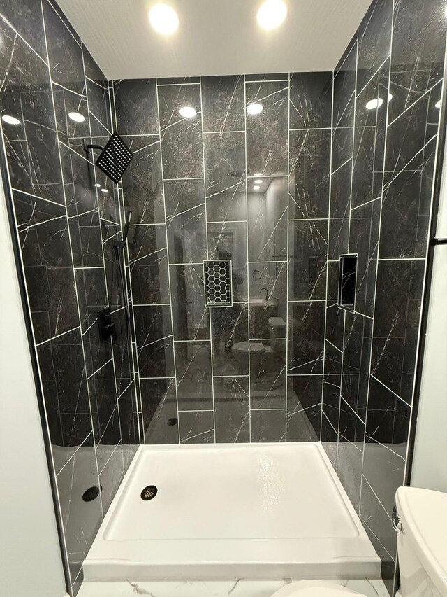 full bathroom with recessed lighting, a shower stall, and toilet