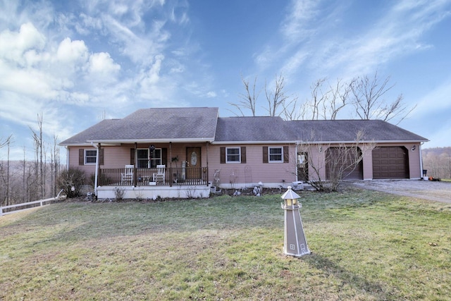 ranch-style house featuring a garage, driveway, a porch, and a front lawn